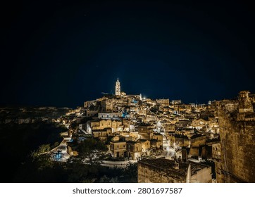 Panoramic view of Matera at night. Sassi di Matera in Italy, historic Sassi cave dwellings and ancient stone architecture in scenic Basilicata landscape