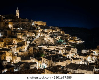 Panoramic view of Matera at night. Sassi di Matera in Italy, historic Sassi cave dwellings and ancient stone architecture in scenic Basilicata landscape