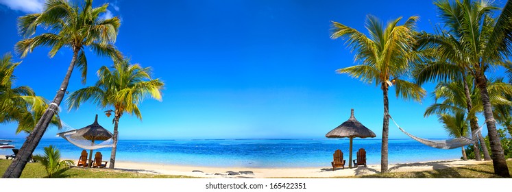 Panoramic View Of Mauritius Beach With Chairs And Umbrellas