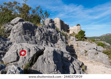 Panoramic view of medieval fortress Starigrad in Omis, Split-Dalmatia, Croatia, Europe. Idyllic hiking trail along rugged landscape in Dinara mountains in the Balkans, Dinaric Alps. Wanderlust concept