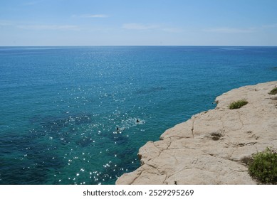 A panoramic view of the Mediterranean Sea with clear blue water, rocky cliffs, and a vast horizon. Perfect for enjoying the beauty of nature - Powered by Shutterstock