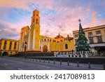 panoramic view of the Metropolitan Cathedral of the Immaculate Conception in the center of the city of Xalapa with a beautiful orange sunrise in the background