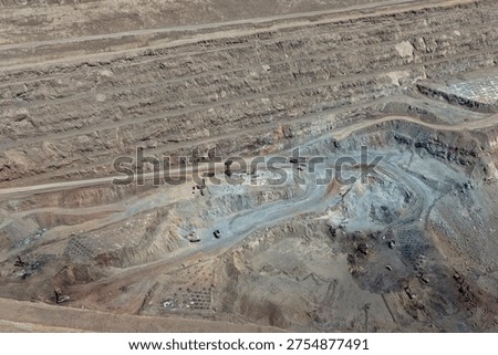 Panoramic view of a mine in the process of blasting and iron ore extraction operations