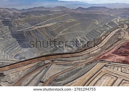 Panoramic view of mining roads next to a huge open pit for copper extraction