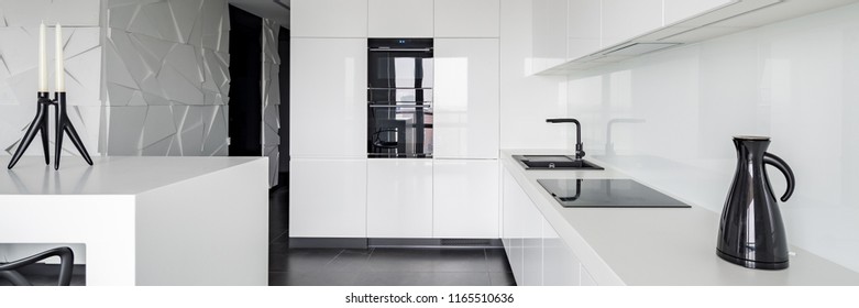 Panoramic View Of Monochromatic White Luxury Kitchen With Black Details