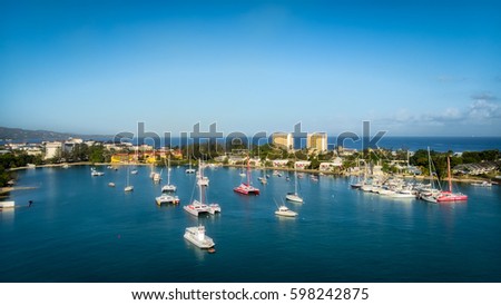 Panoramic view of Montego Bay, Jamaica on a stunning spring day featuring boats floating in the emerald waters of the bay