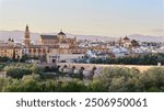 Panoramic view of the Mosque-Cathedral across the Calahorra Tower and the Roman Bridge over the Guadalquivir River, Cordoba, Andalusia, Spain.