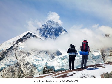 Panoramic view of Mount Everest from Kala Patthar with two tourists on the way to Everest base camp, Sagarmatha national park, Khumbu valley - Nepal