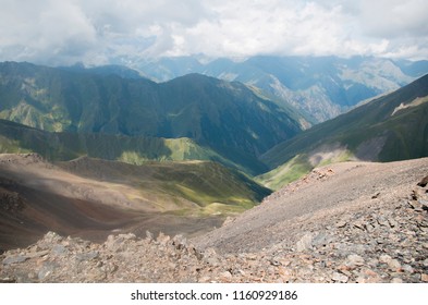 Panoramic view to the mountain range in summer. Colorful and bright background. Beautiful hills for tourists to hike or descend.