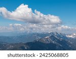 Panoramic view from mountain summit Foelzstein in wild Hochschwab massif, Styria, Austria. Looking at majestic Ennstaler Alps in Gesaeuse national park in distance. Wanderlust in remote Austrian Alps