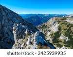 Panoramic view from mountain summit Foelzstein in wild Hochschwab massif, Styria, Austria. Looking at majestic Ennstaler Alps in Gesaeuse national park in distance. Wanderlust in remote Austrian Alps