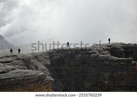 panoramic view of the mountain summit with unrecognizable people and smoke resembling an active volcano