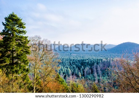 Panoramic view of the mountains against cloudy blue sky on a sunny winter day. Parc Naturel Régional des Vosges du Nord. France, Lorraine