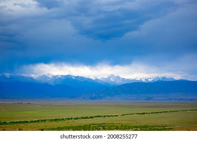 Panoramic view of mountains in the distance, blue clouds over mountains, cyclone, storm warning.