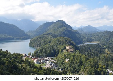 Panoramic view from Neuschwanstein castle at southern Bavaria. Forest, hills and lakes and the Hohenschwangau Castle at the horizon. Bavaria, Germany, September 2021