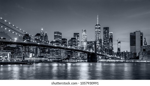 panoramic view new york city downtown manhattan skyline at night with skyscrapers and brooklyn bridge - Shutterstock ID 1057930991