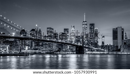 panoramic view new york city downtown manhattan skyline at night with skyscrapers and brooklyn bridge