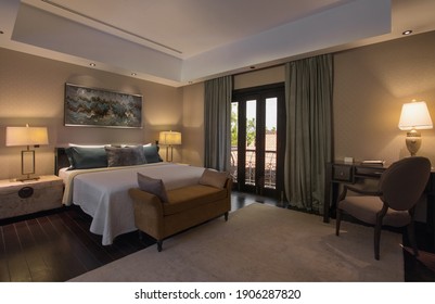 Panoramic view of nice stylish hotel room with bed in the center 