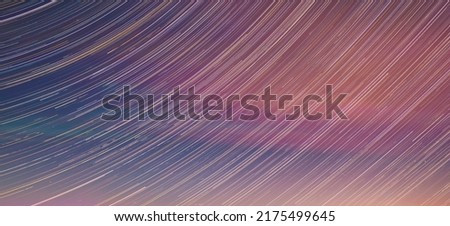 Panoramic View Of Night Sky. Unusual Stars Effect Sky. Meteors Fly Across Night Sky. Large Exposure. Blurred Stars In Soft Colors. Light Magenta Background. Amazing In Blue-Pink Sky.