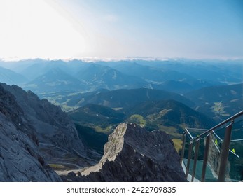 Panoramic view of observation deck of skywalk rope bridge at Dachstein Mountains, Northern Limestone Alps, Styria, Austria. Looking at mountain ranges of Austrian Alps. Peace of mind. Aerial landscape