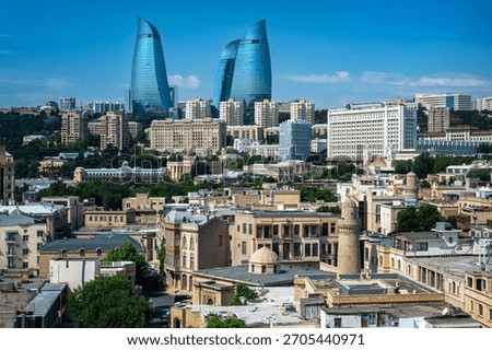 Panoramic view of Baku’s old town architecture with modern towers and city buildings in the background under a clear sky.