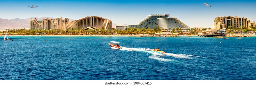 Panoramic view on central public beach with water sport activities– famous tourist resort city in Eilat - famous resort city in Israel, Middle East - Powered by Shutterstock