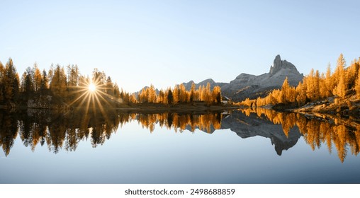 Panoramic view on Federa Lake and Croda da Lago mountains in Autumn time. Bright orange larches glowing by sunrise light. Lago di Federa, Dolomite Apls, Cortina D'Ampezzo, Dolomites, Italy - Powered by Shutterstock