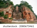 Panoramic view on The Giant Buddha of Leshan from the river, Leshan, Sichuan, China. UNESCO World Heritage site. Focus on the face
