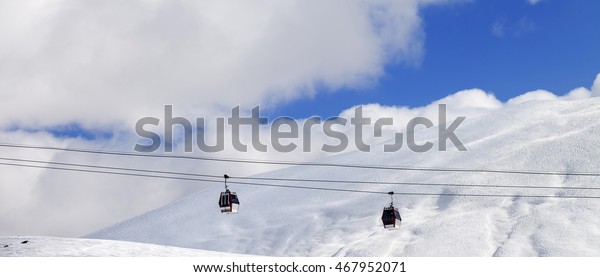 Panoramic view on\
gondola lifts and off-piste slope at sun day. Caucasus Mountains,\
Georgia, region\
Gudauri.