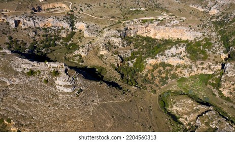 Panoramic view on the Gravine di Matera in Basilicata, Italy. The ravines are erosive incisions similar to canyons found in the province of Matera and are typical karst morphologies of the Murgia. - Shutterstock ID 2204560313