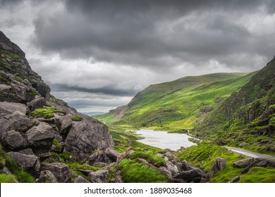 Panoramic View On Green Mountain Hills And A Lake In Gap Of Dunloe. Dramatic Stormy Sky In Black Valley, Ring Of Kerry, County Kerry, Ireland