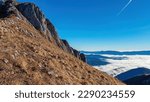 A panoramic view on mount Eisenerzer Reichenstein (2165m) near Eisenerz in Styria, Austria, Europe. Austrian Alps. The Ennstal valley is covered in clouds and fog. Hiking trail,Wanderlust. Sunny day