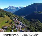 Panoramic view on mountain villages, green forests and apline meadows near Saint-Gervais-les-Bains, Savoy, France in summer