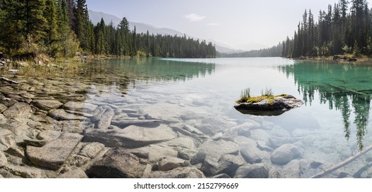 Panoramic view on pristine alpine lake with greenish colour, Jasper National Park, Canada