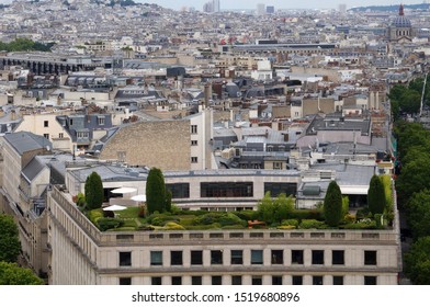 Panoramic view on roofs of Paris, seen from the top of Arc de Triomphe when looking towards Butte Montmartre in the backround, with a wonderful private garden on a green roof - Powered by Shutterstock