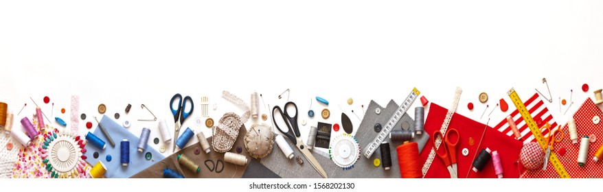 Panoramic view on sewing composition with threads, fabrics, scissors, buttons, needles, pins and other sewing accessories on white background. Long banner, top view, copy space, flat lay, mock up - Powered by Shutterstock