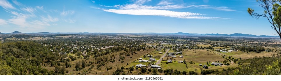 Panoramic view on the town suburb houses situated in picturesque valley surrounded by the hills. Porcupine lookout, Gunnedah, New South Wales, Australia