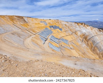 Panoramic view of one side of an open pit mine on a sunny mornin