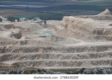Panoramic View of an Open Pit Limestone Quarry with Mining Excavation Terraces