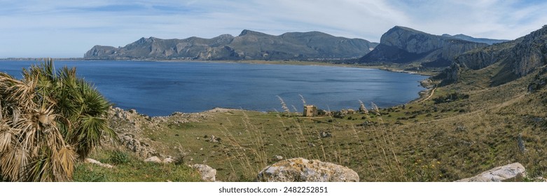 Panoramic view over mediterranean coastline with bay of water at Nature Park Monte Cofano with historical watchtower, San Vito Lo Capo, Sicily, Italy - Powered by Shutterstock