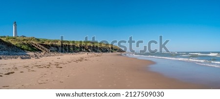 Panoramic view over seashore, beach and lighthouse in Hirtshals, Denmark, summer, at blue sky and sunny day