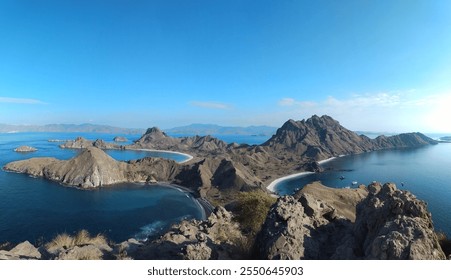 Panoramic view of Padar Island, Komodo National Park, Indonesia, featuring turquoise bays, rugged hills, and pristine beaches under a clear blue sky. A UNESCO World Heritage treasure - Powered by Shutterstock