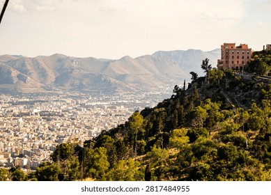 Panoramic view of Palermo cityscape and distant mountains from Monte Pellegrino with Castle Utveggio on the hilltop