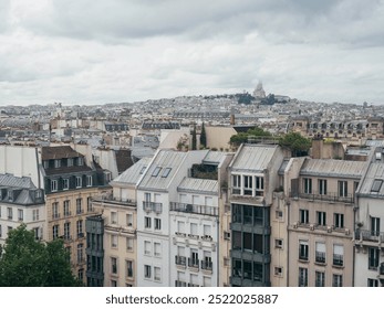 Panoramic View of Paris Rooftops with Sacré-Cœur in the Distance. - Powered by Shutterstock