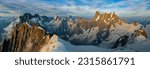 A panoramic view of the peaks and glaciers of the Mont Blanc massif at sunset.