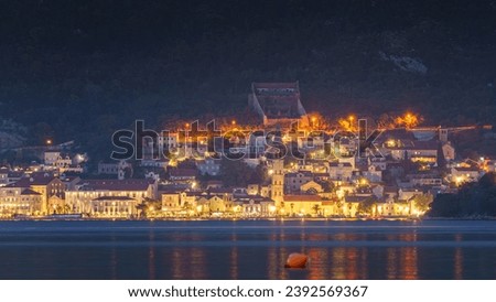 Panoramic view of Perast city at nighttime with street lighting, Kotor bay, Montenegro