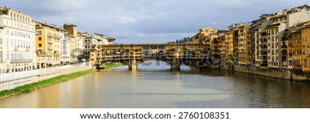 Panoramic view of Ponte Vecchio in Florence, Tuscany, Italy, opened in 1345, spanning the Arno River featuring medieval market stalls	