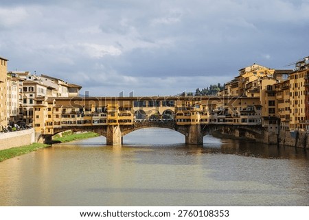 Panoramic view of Ponte Vecchio in Florence, Tuscany, Italy, opened in 1345, spanning the Arno River featuring medieval market stalls	