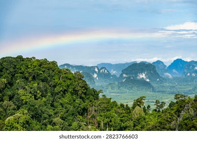 Panoramic view of rainbow over limestone karst mountains from Tiger Cave Temple, Krabi, Thailand