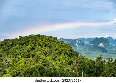 Panoramic view of rainbow over limestone karst mountains from Tiger Cave Temple, Krabi, Thailand